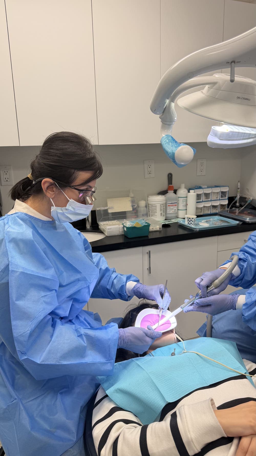 Dentist providing dental treatment to a patient at Smile Dental Arts Centre in Markham